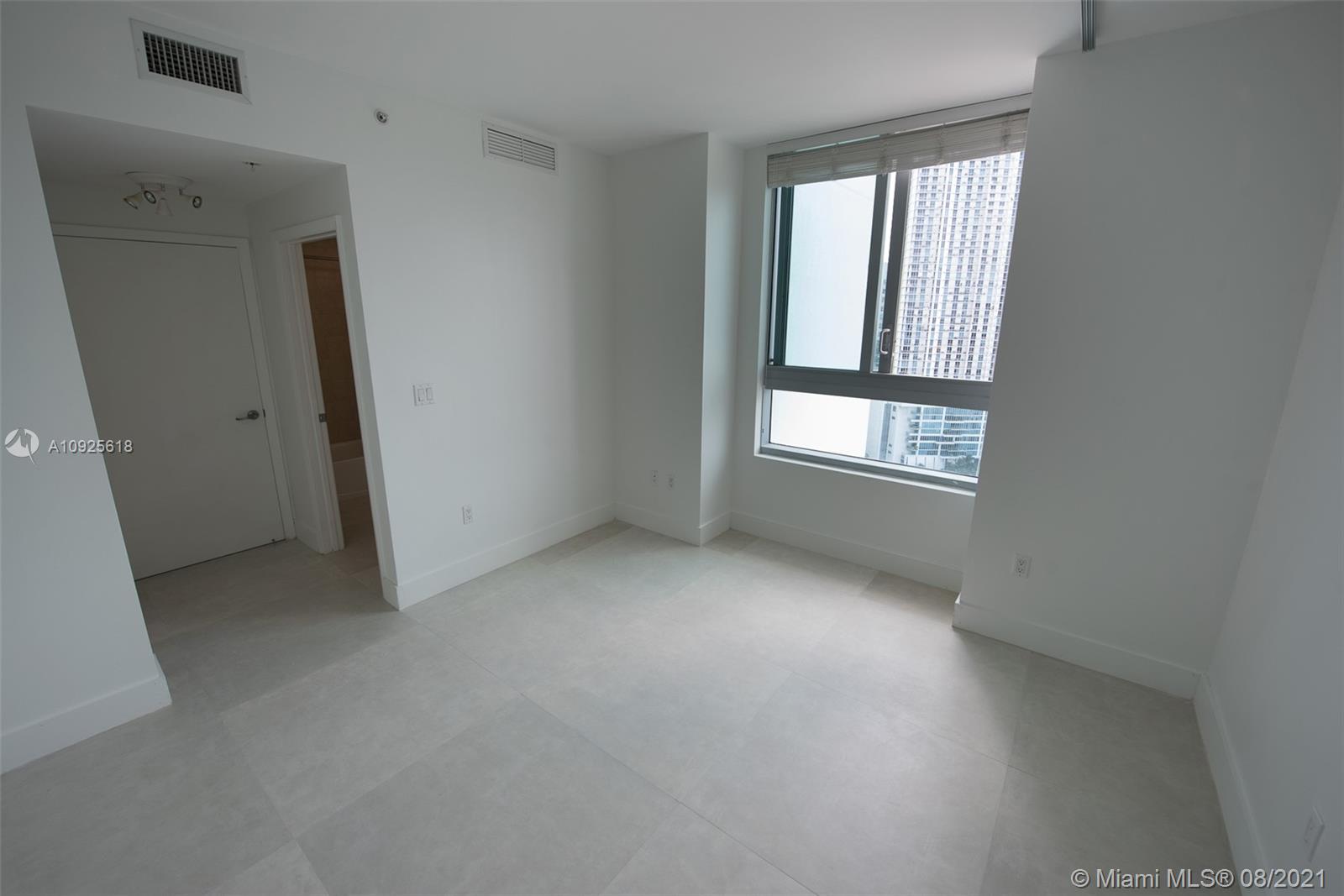 90 Southwest 3rd Street, Unit 2411 Miami, FL 33130 - Photo 18 of 22 an empty room with windows and closet