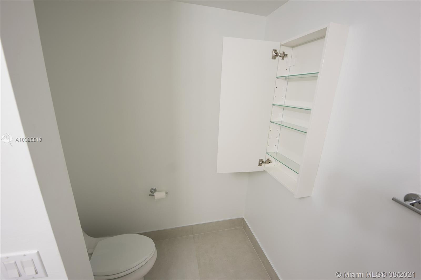 90 Southwest 3rd Street, Unit 2411 Miami, FL 33130 - Photo 20 of 22 a bathroom with a toilet and a shower