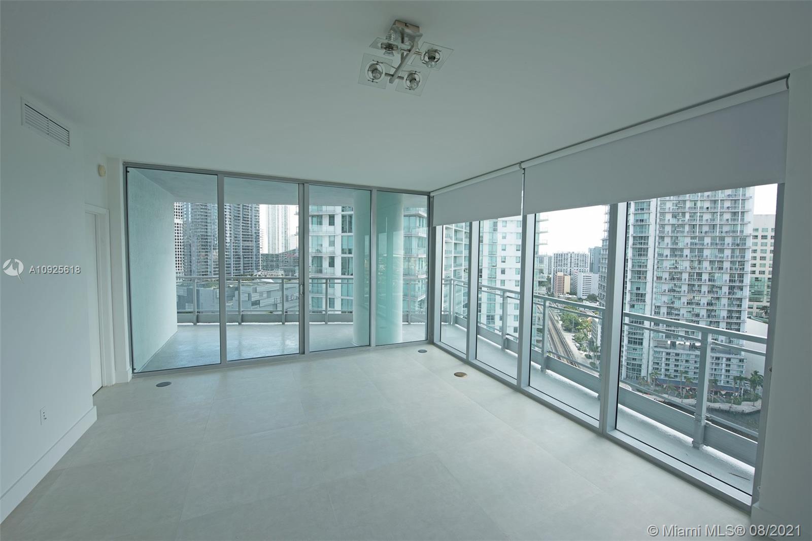 90 Southwest 3rd Street, Unit 2411 Miami, FL 33130 - Photo 4 of 22 a view of an empty room with windows