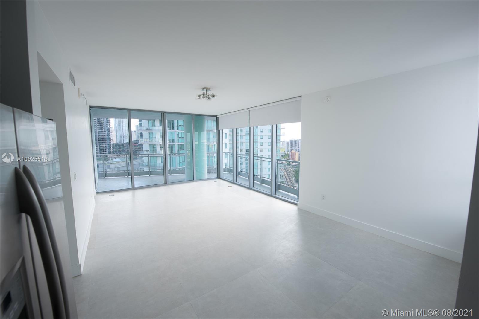 90 Southwest 3rd Street, Unit 2411 Miami, FL 33130 - Photo 5 of 22 a view of an empty room with glass door and a window