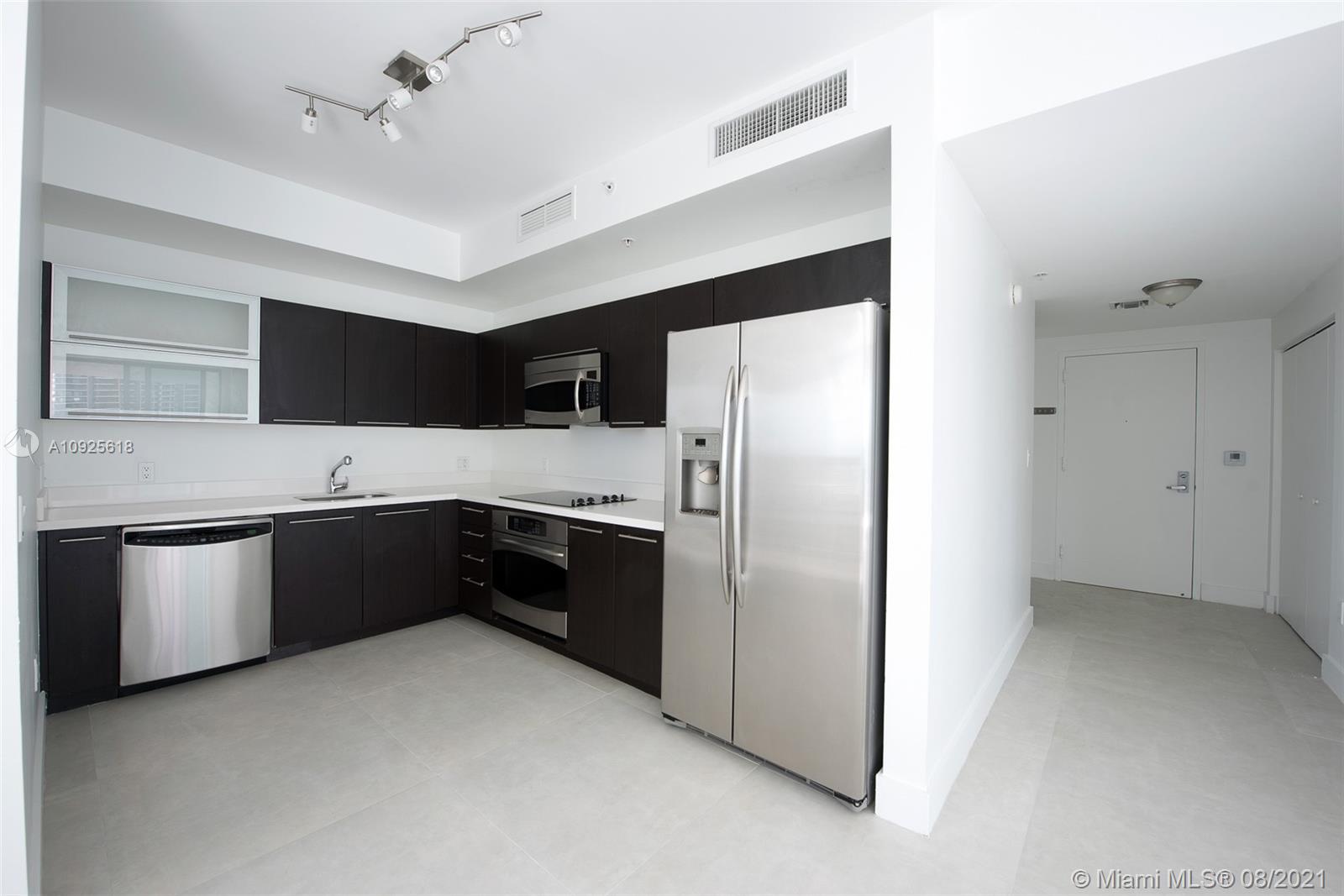 90 Southwest 3rd Street, Unit 2411 Miami, FL 33130 - Photo 6 of 22 a large kitchen with stainless steel appliances granite countertop a refrigerator and a sink