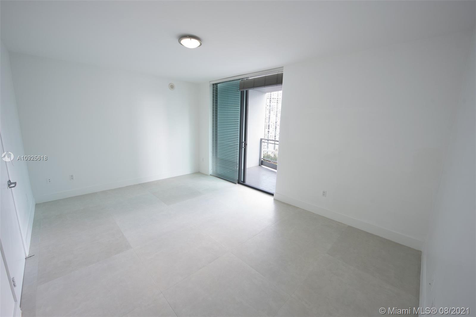 90 Southwest 3rd Street, Unit 2411 Miami, FL 33130 - Photo 9 of 22 a view of an empty room with closet and a window