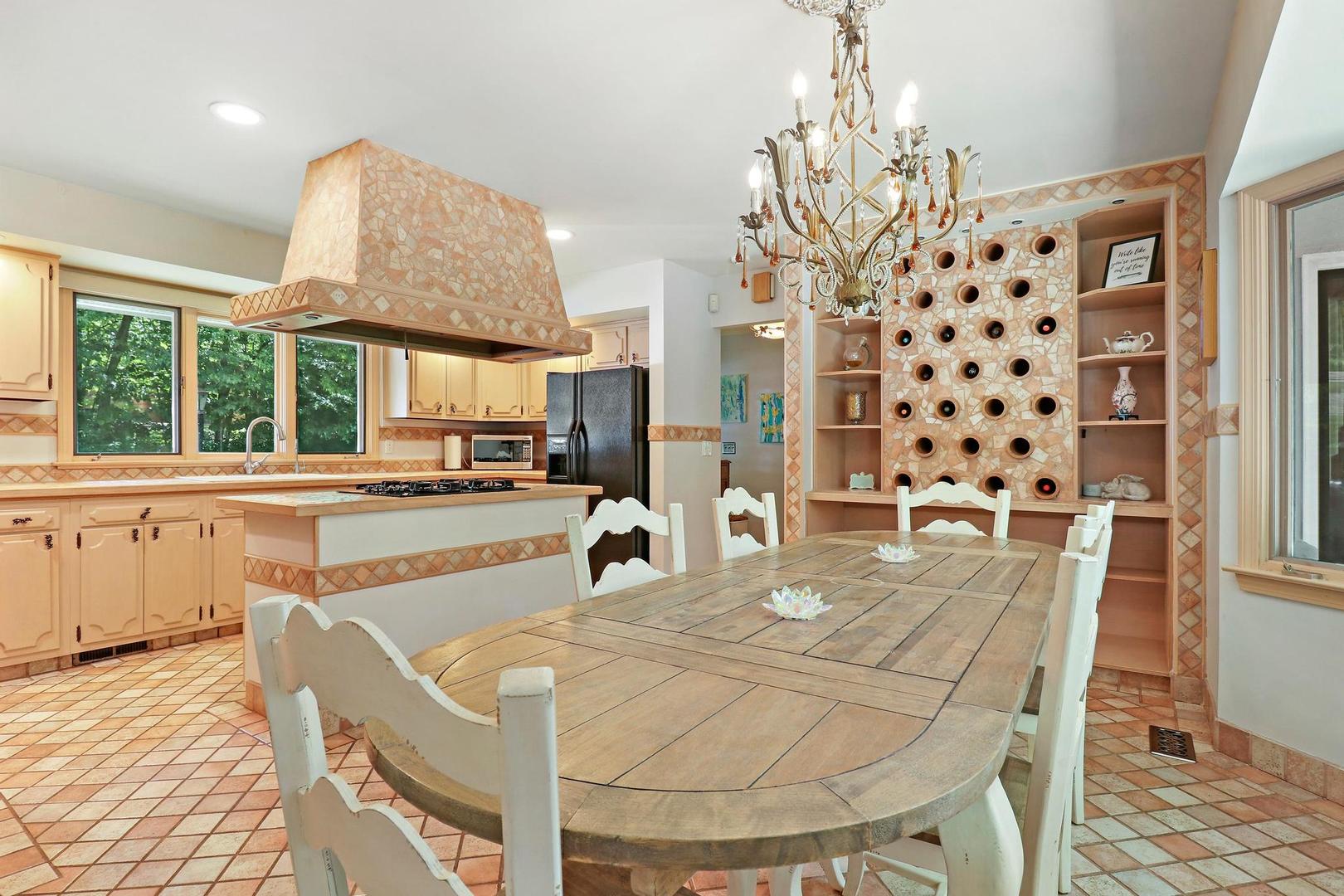 112 River Drive Trout Valley, IL 60013 - Photo 11 of 28 a dining hall with stainless steel appliances kitchen island granite countertop a table and chairs