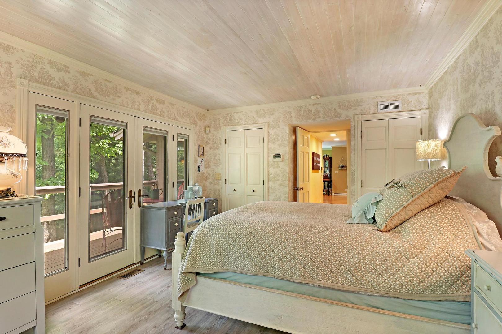 112 River Drive Trout Valley, IL 60013 - Photo 13 of 28 a bedroom with a large bed and wooden floor