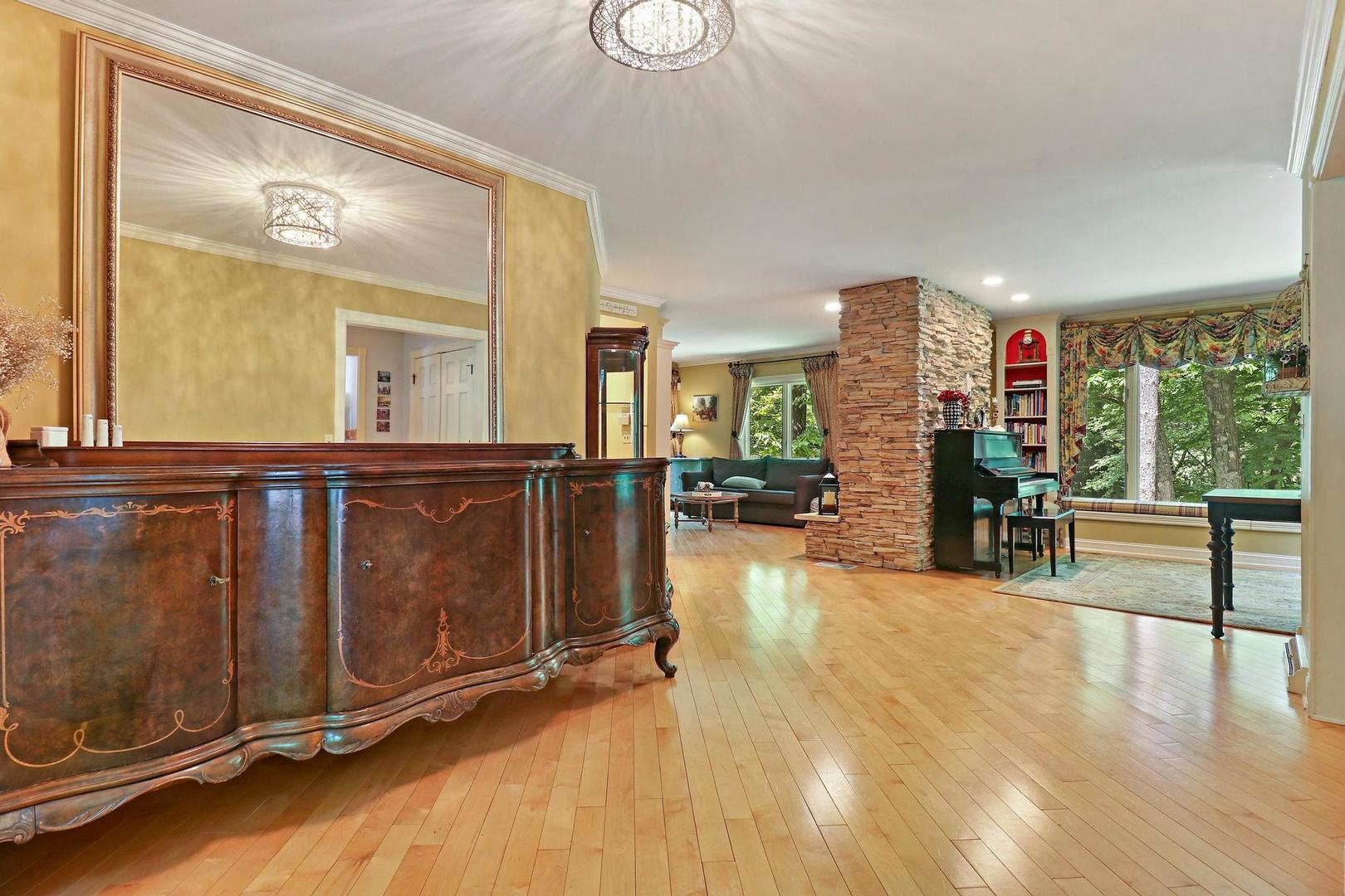 112 River Drive Trout Valley, IL 60013 - Photo 7 of 28 a view of a living room and kitchen with furniture wooden floor and a large window