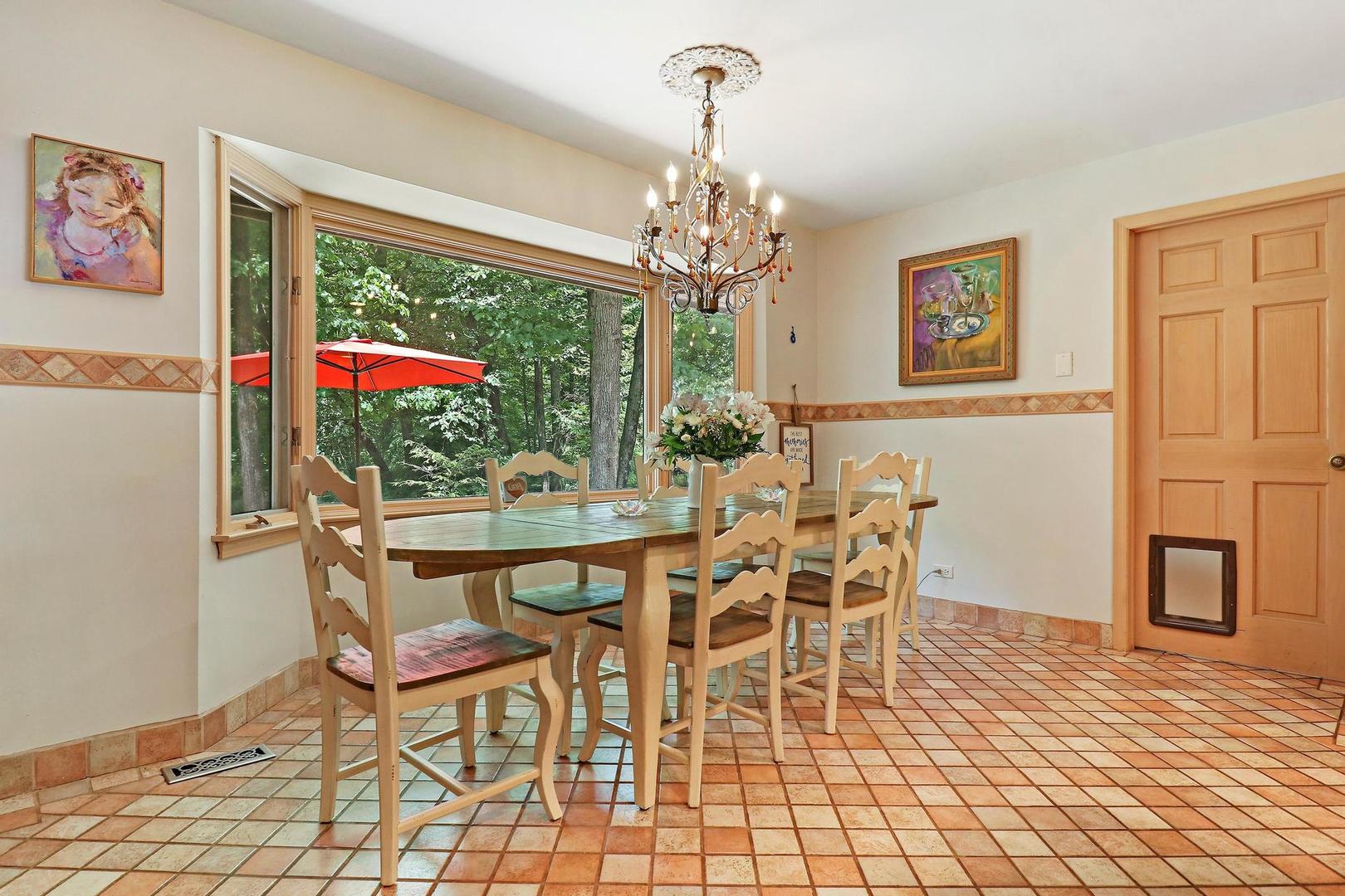 112 River Drive Trout Valley, IL 60013 - Photo 10 of 28 a view of a dining room with furniture a chandelier and wooden floor