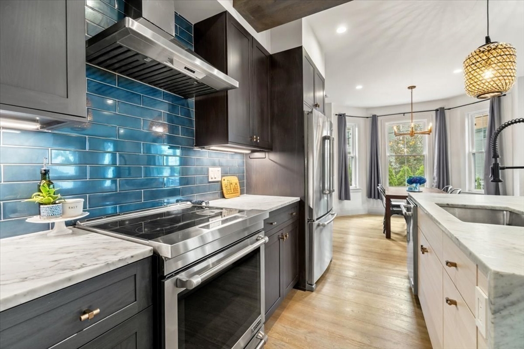 3 Adrian Street, Unit 3 Somerville, MA 02143 - Photo 8 of 31 a kitchen with a sink and stove
