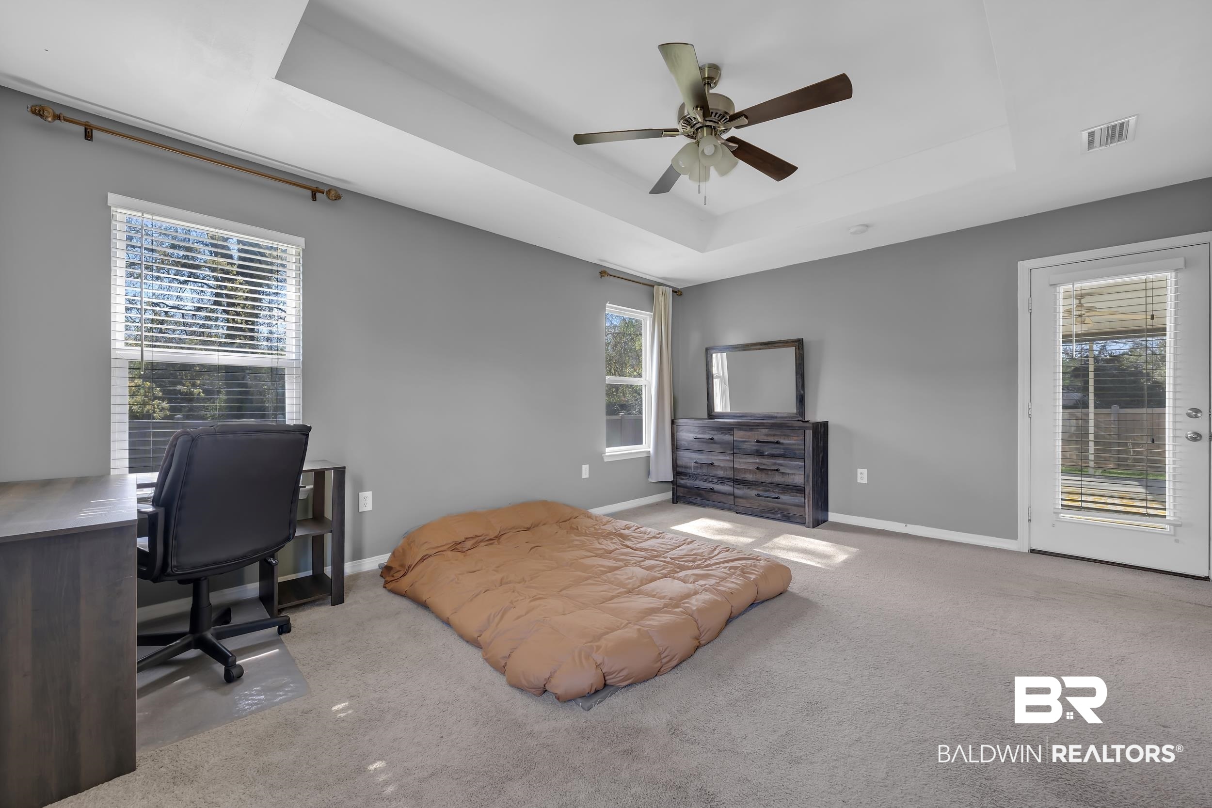 31527 Heidelbrook Loop Daphne, AL 36527 - Photo 11 of 22 Bedroom with carpet flooring, a desk, access to exterior, a raised ceiling, and ceiling fan