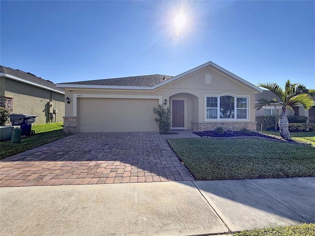 469 Ogelthorpe Drive Davenport, FL 33897 - Photo 2 of 10 a front view of a house with a yard and garage