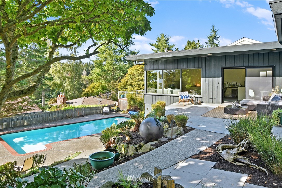 a view of a patio with table and chairs potted plants