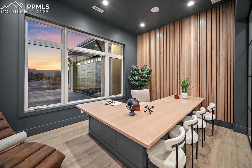 13525 Random Ridge View Colorado Springs, CO 80921 - Photo 36 of 43 A study featuring a custom wood slatted accent wall that enhances the home’s sophisticated design.