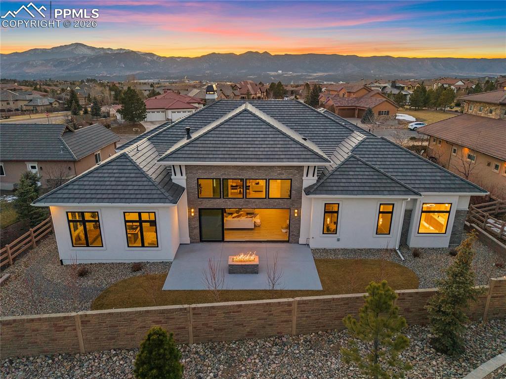 13525 Random Ridge View Colorado Springs, CO 80921 - Photo 42 of 43 A beautifully designed, low-maintenance backyard featuring a striking fire pit that creates the perfect space for indoor-outdoor living and entertaining.