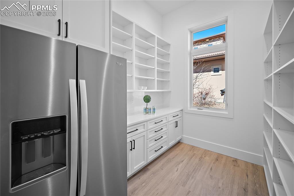13525 Random Ridge View Colorado Springs, CO 80921 - Photo 10 of 43 Walk-in pantry with custom cabinetry and fridge