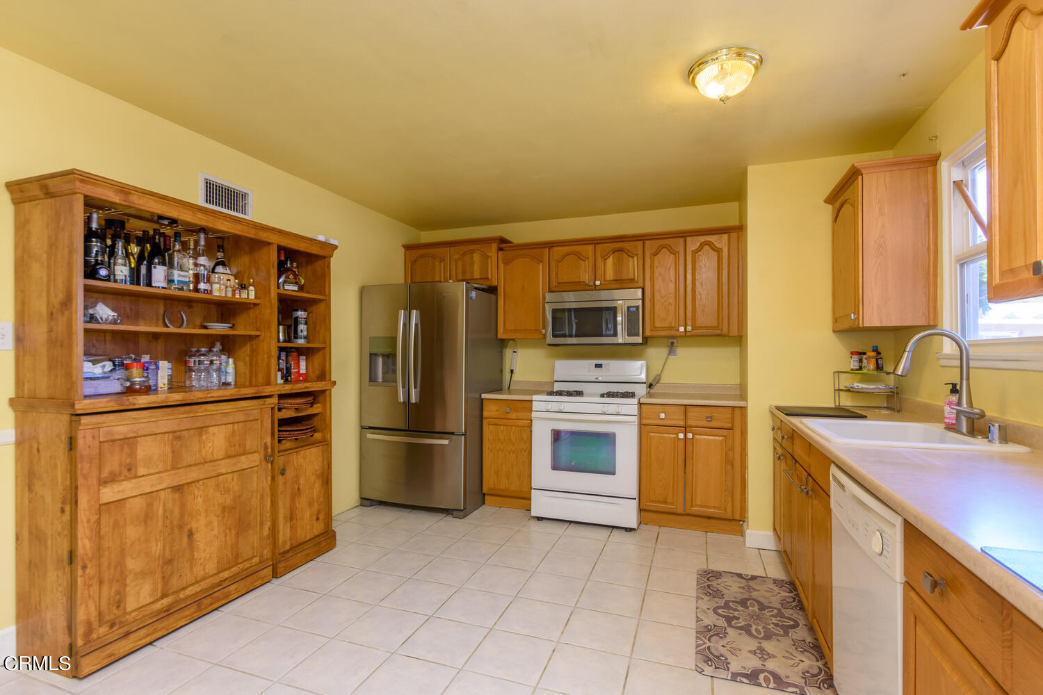 6283 Marsha Avenue Simi Valley, CA 93063 - Photo 7 of 21 a kitchen with stainless steel appliances a refrigerator stove and sink