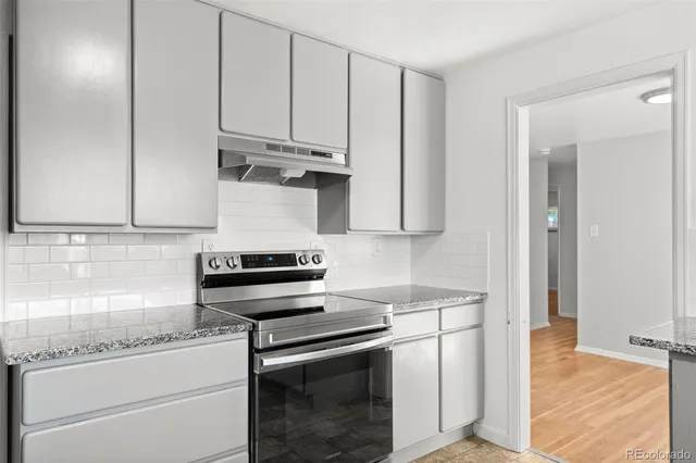a kitchen with stainless steel appliances white cabinets and a sink