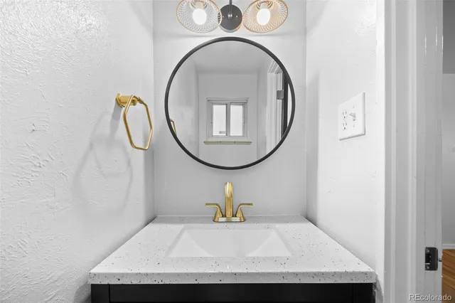 a picture of a bathroom with a sink and a mirror