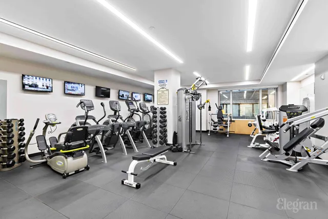a view of a hallway with the couches and chandelier