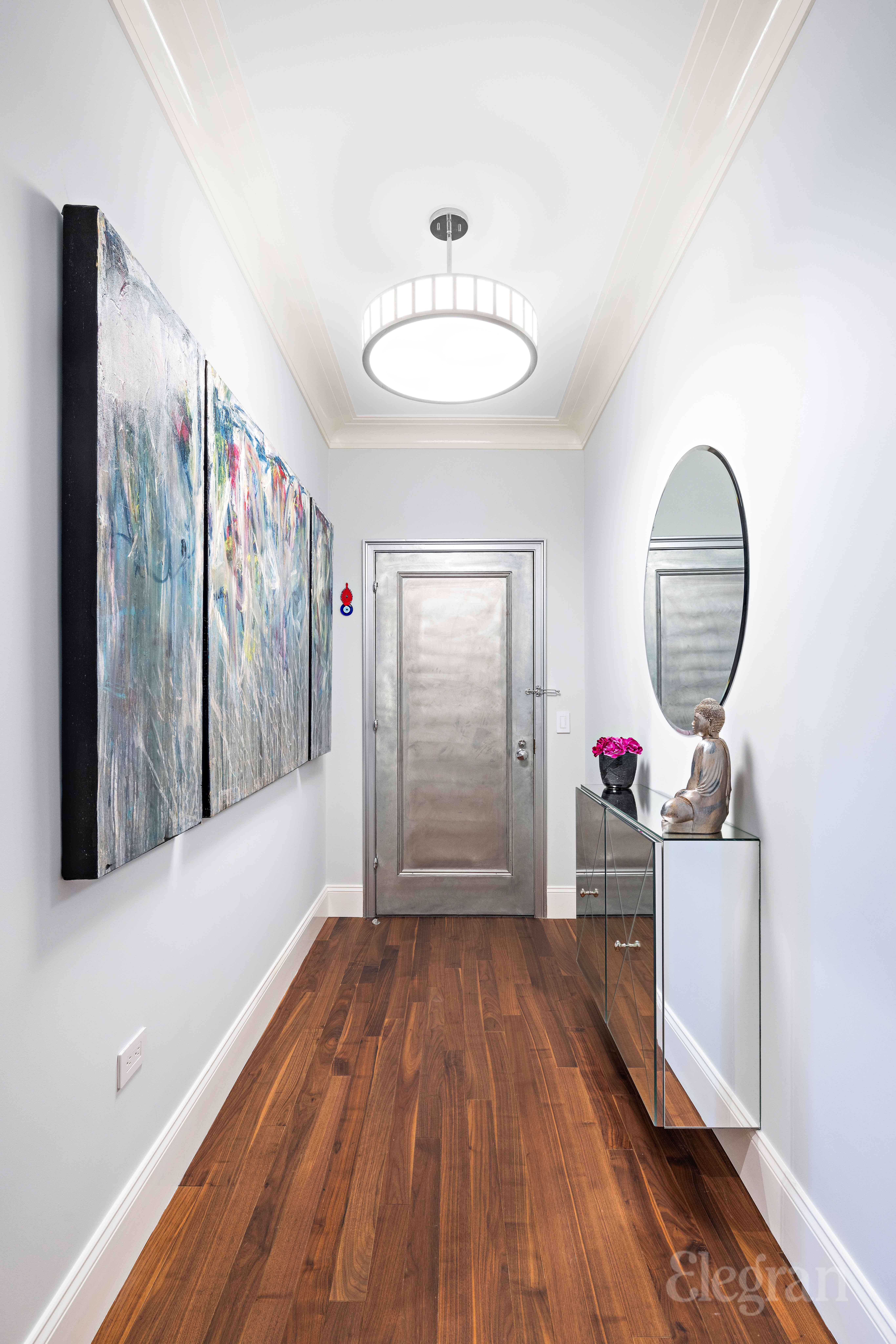 465 Park Avenue, Unit 18E Manhattan, NY 10022 - Photo 8 of 15 a view of a room with wooden floor window and a mirror