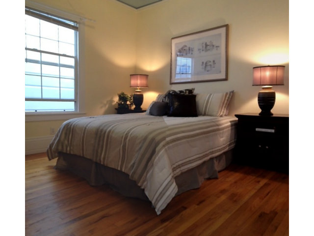 374 Rolph Street San Francisco, CA 94112 - Photo 12 of 20 a bedroom with a bed and wooden floor