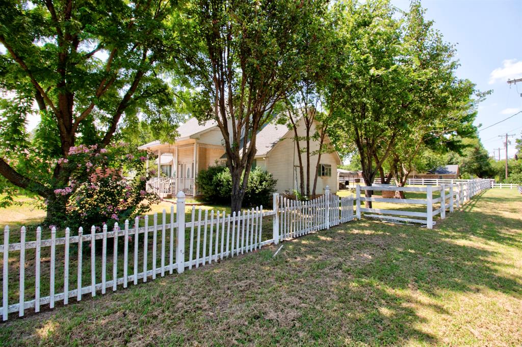 503 Sherman Street Tioga, TX 76271 - Photo 7 of 13 White picket fence framing a expansive lawn