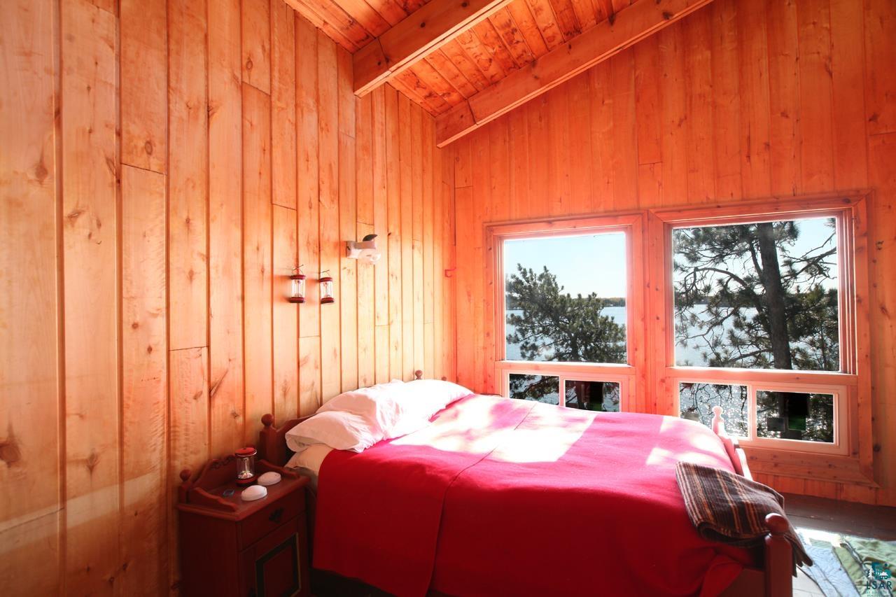 3-4 Wakemup Narrows North Cook, MN 55723 - Photo 15 of 41 Bedroom featuring vaulted ceiling with beams, wood walls, and wood ceiling