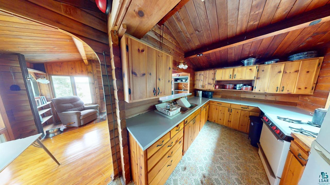 3-4 Wakemup Narrows North Cook, MN 55723 - Photo 16 of 41 Kitchen featuring vaulted ceiling with beams, white range, wood ceiling, light hardwood / wood-style floors, and sink