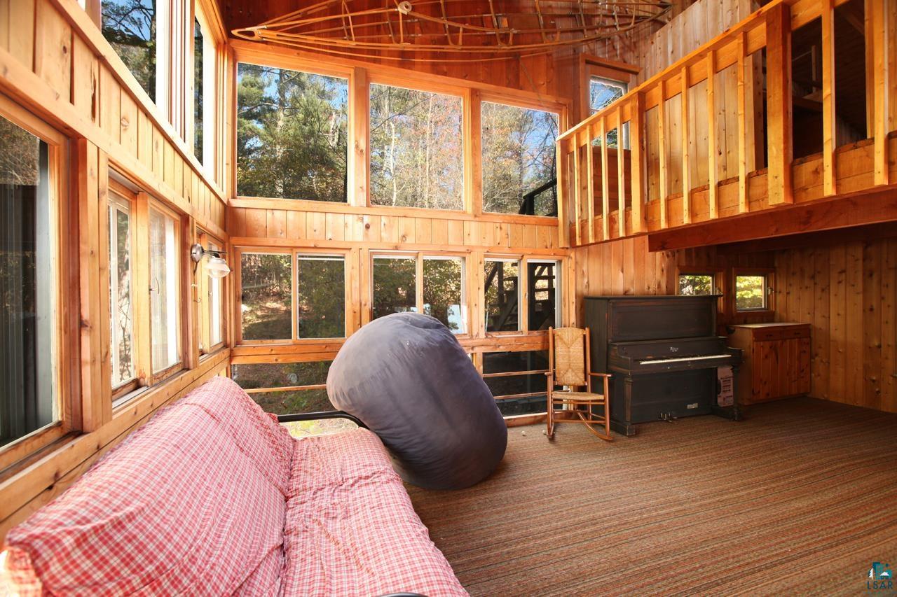 3-4 Wakemup Narrows North Cook, MN 55723 - Photo 6 of 41 Living room featuring high vaulted ceiling, wood walls, and a wealth of natural light