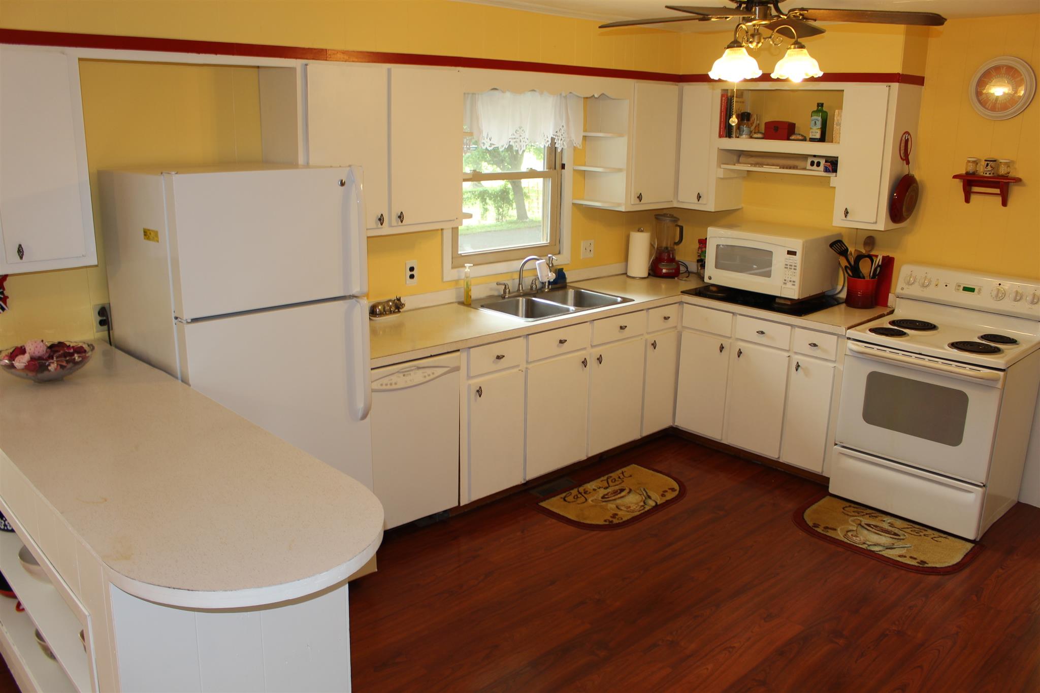6740 Summitville Road Morrison, TN 37357 - Photo 4 of 30 a kitchen with a refrigerator sink and white cabinets