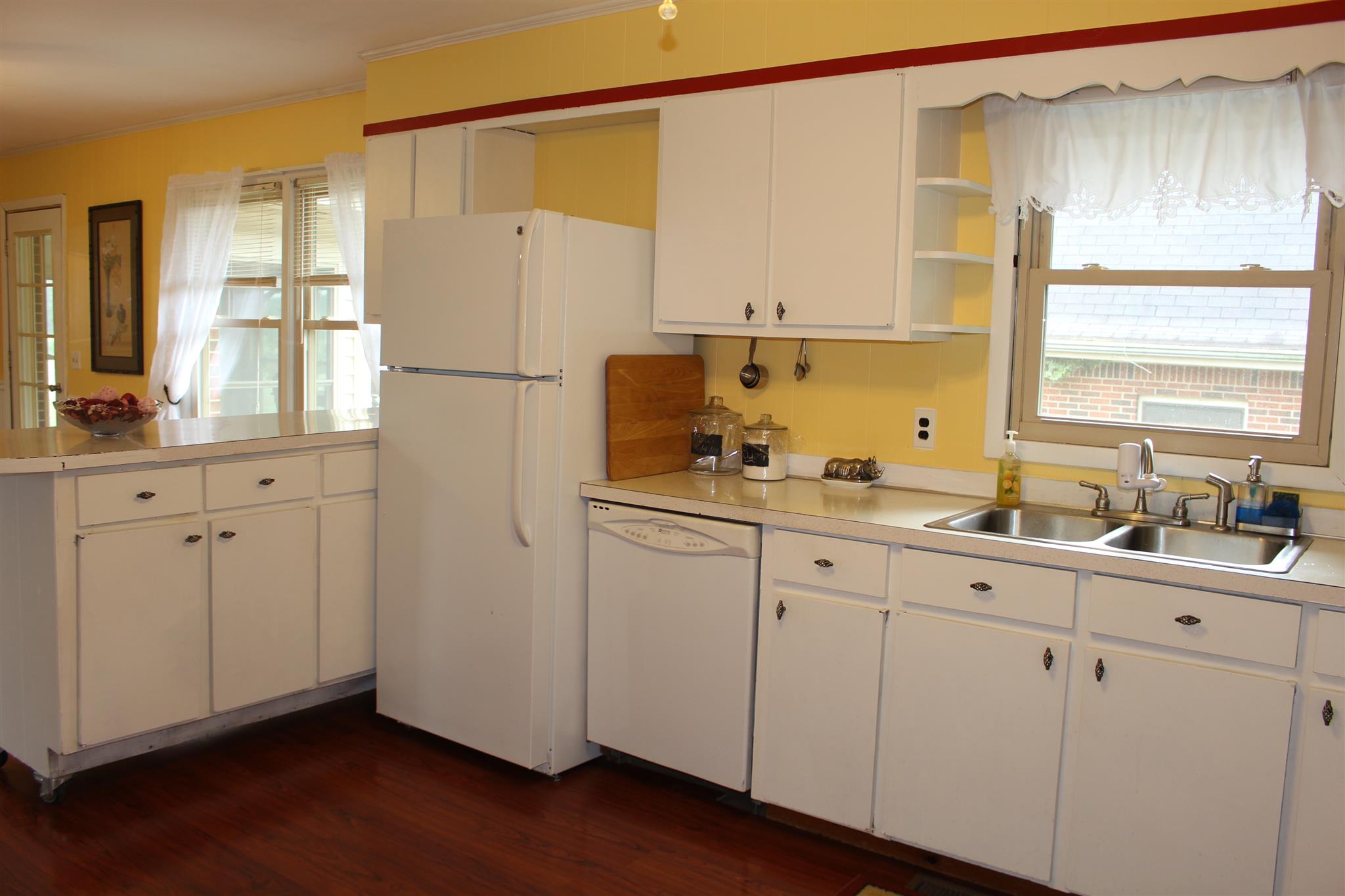 6740 Summitville Road Morrison, TN 37357 - Photo 5 of 30 a kitchen with white cabinets and white appliances
