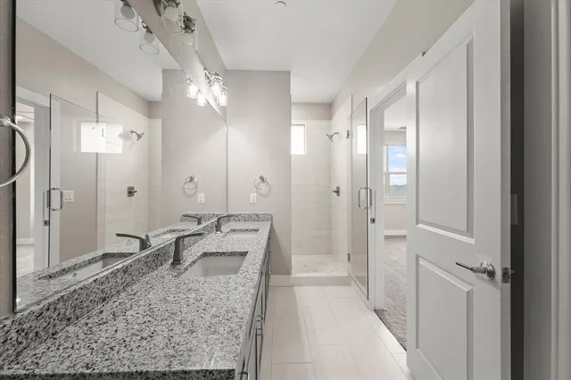 an empty room with a bathroom and a window