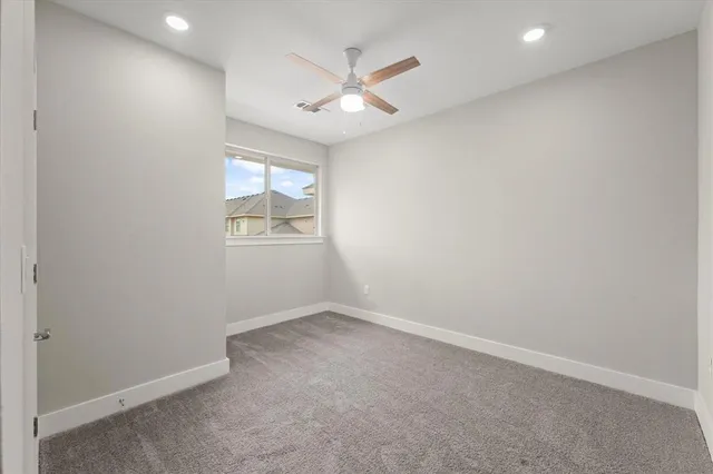 a bathroom with a granite countertop sink a toilet and shower