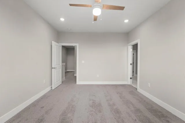 a bathroom with a granite countertop sink a toilet and a mirror