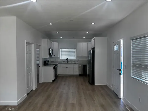 a view of a hallway with wooden floor