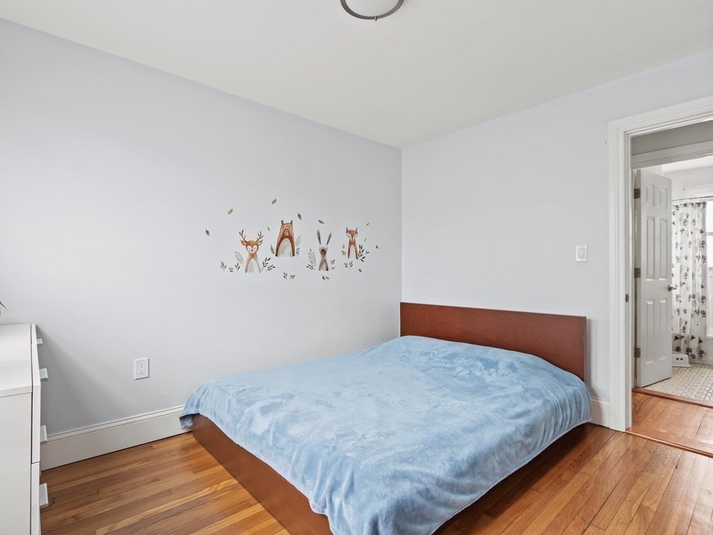16-18 Kimball Road Watertown, MA 02472 - Photo 13 of 37 a bedroom with a bed and wooden floor