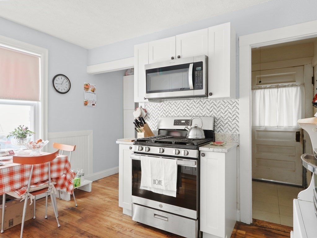 16-18 Kimball Road Watertown, MA 02472 - Photo 20 of 37 a kitchen with a stove and wooden floor