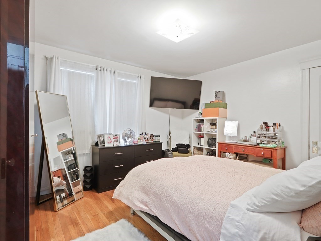 16-18 Kimball Road Watertown, MA 02472 - Photo 22 of 37 a bedroom with a bed and a flat screen tv