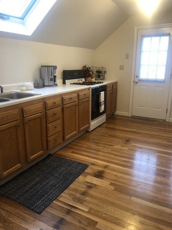 16-18 Kimball Road Watertown, MA 02472 - Photo 32 of 37 a kitchen with stainless steel appliances granite countertop a sink stove and cabinets