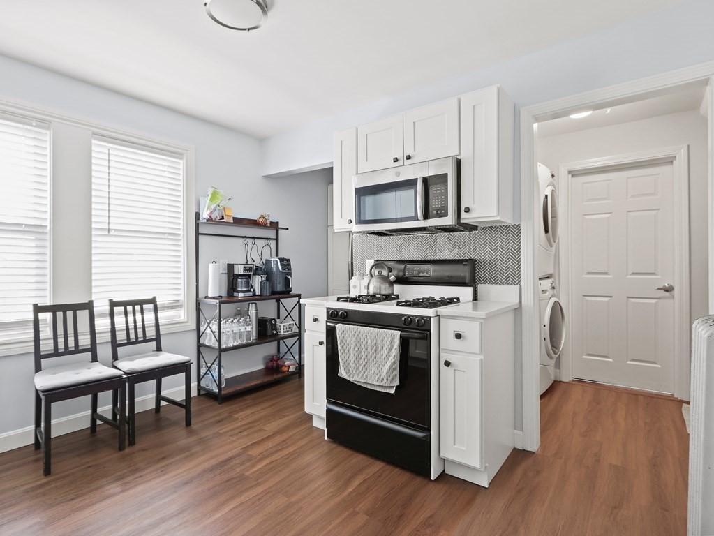 16-18 Kimball Road Watertown, MA 02472 - Photo 4 of 37 a kitchen with stainless steel appliances a stove a microwave a sink and cabinets
