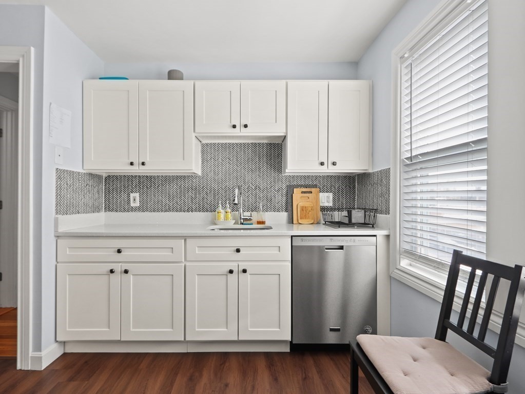 16-18 Kimball Road Watertown, MA 02472 - Photo 6 of 37 a kitchen with white cabinets and sink