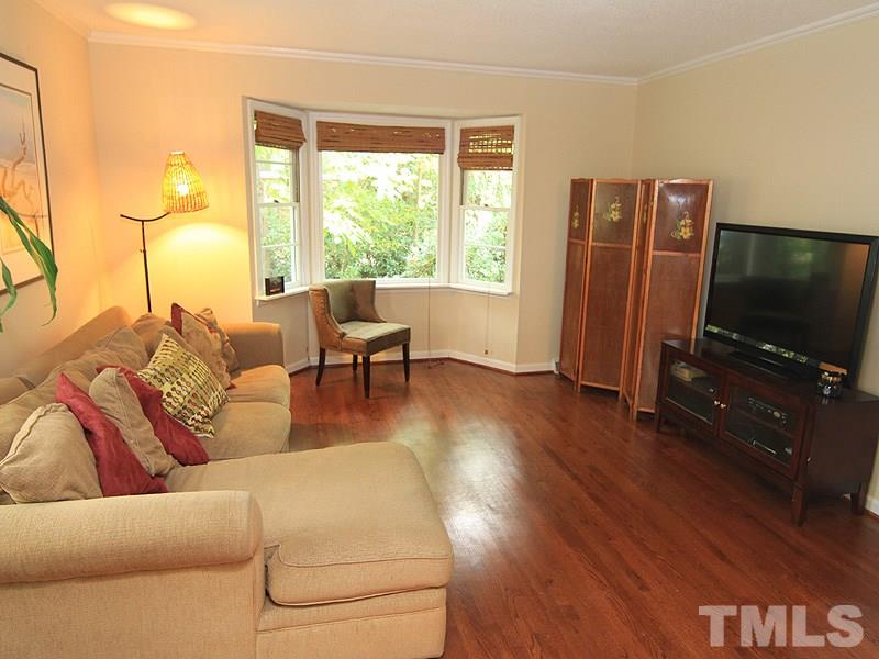 1009 Paddock Drive Raleigh, NC 27609 - Photo 11 of 18 a living room with furniture and a flat screen tv