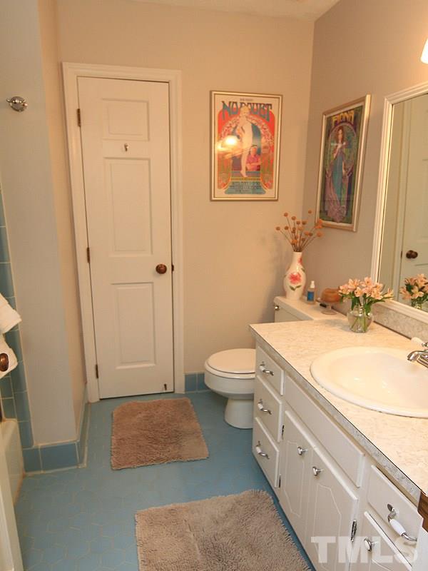 1009 Paddock Drive Raleigh, NC 27609 - Photo 9 of 18 a spacious bathroom with a granite countertop sink and a mirror