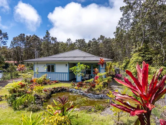 a view of a house with a flower garden