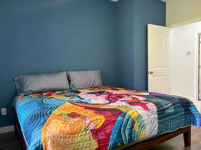 a bedroom with a bed and a window