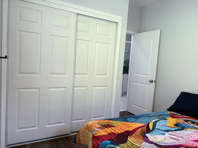 a bedroom with a bed and a window