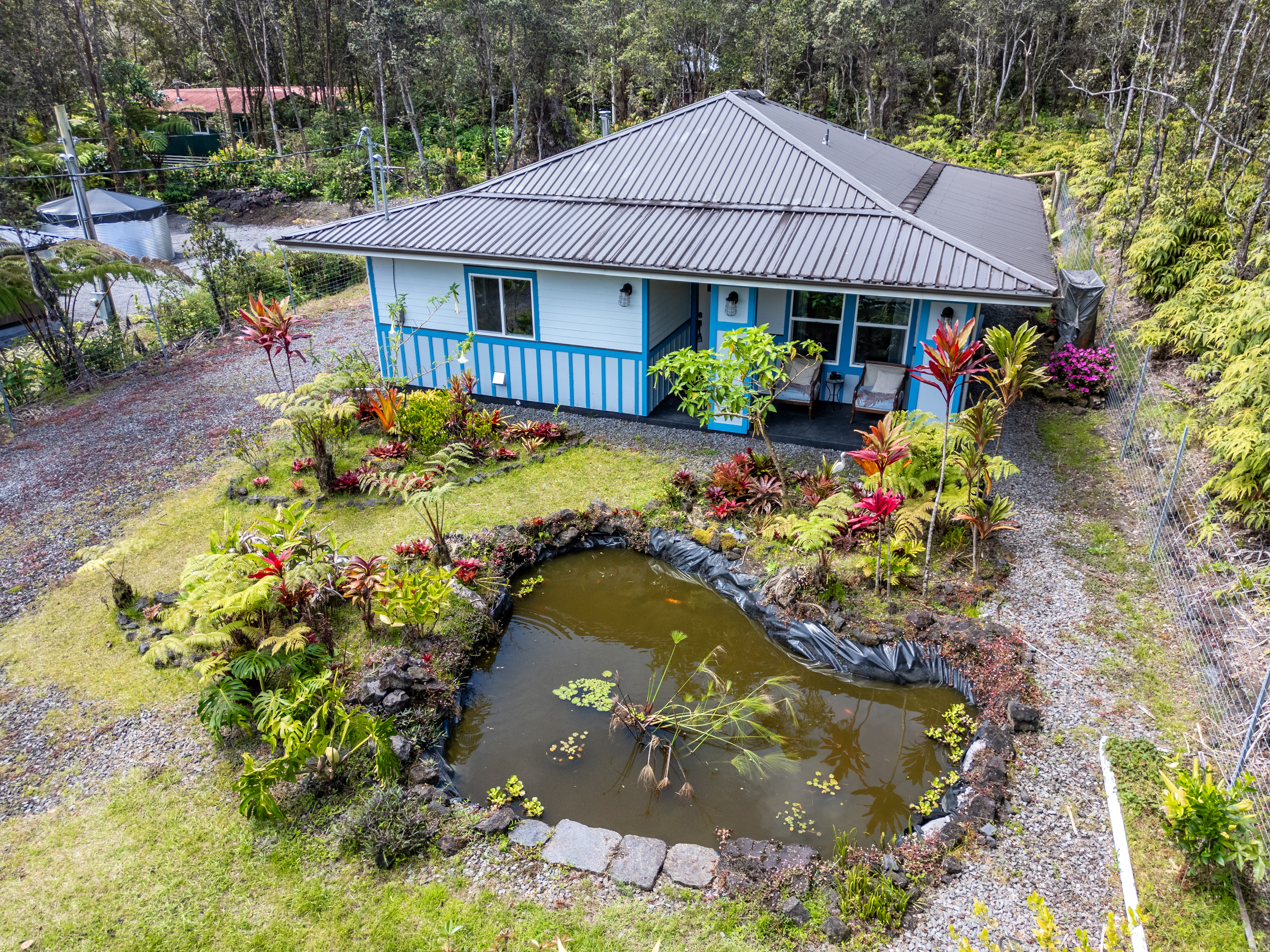 11-3927 Liona Street Volcano, HI 96785 - Photo 27 of 30 a front view of a house with a yard and fountain