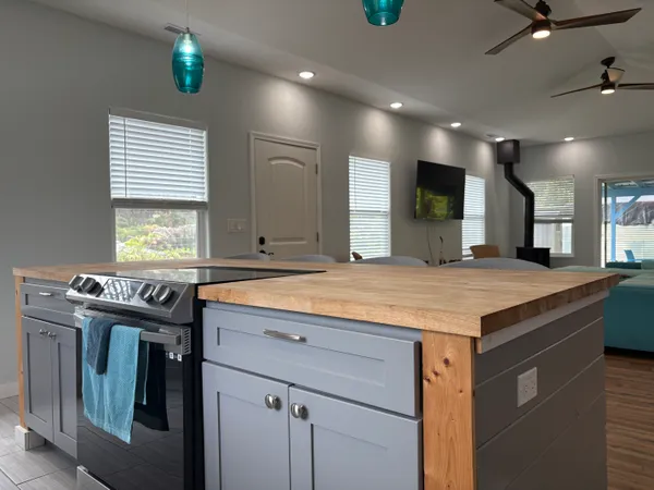 a kitchen with kitchen island a sink stainless steel appliances and cabinets