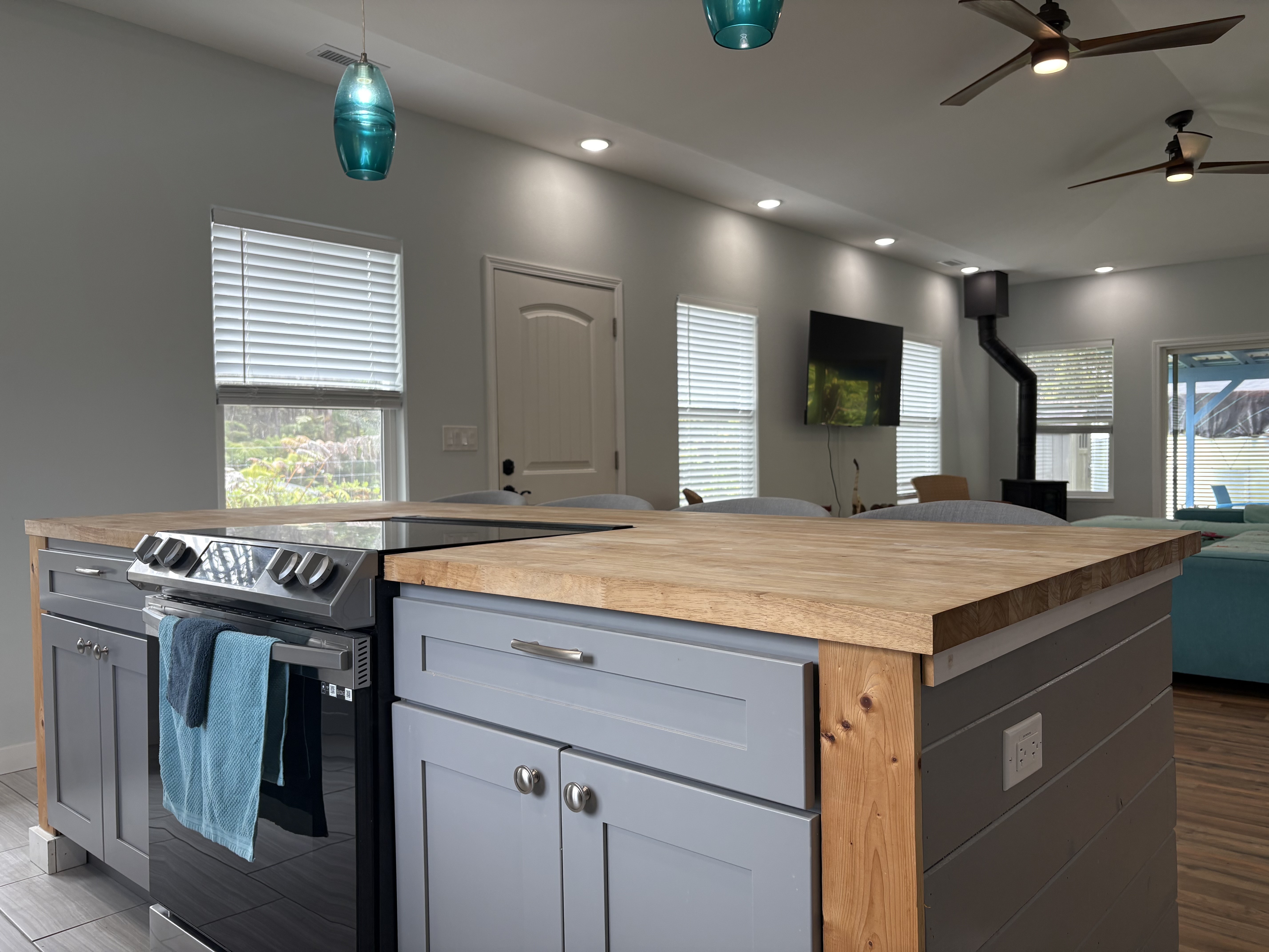 11-3927 Liona Street Volcano, HI 96785 - Photo 4 of 30 a kitchen with kitchen island a sink stainless steel appliances and cabinets