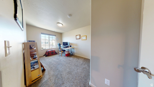 1674 Eastridge Road Price, UT 84501 - Photo 22 of 34 Carpeted room featuring a large window, neutral wall paint, a built-in ceiling light fixture, and a smoke detector