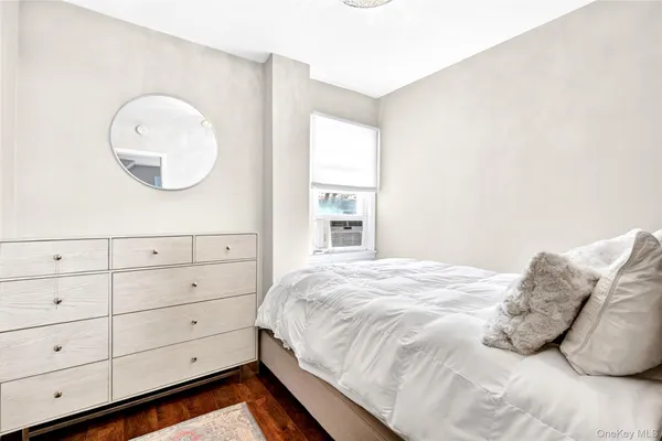 a large bed sitting in a bedroom next to a window