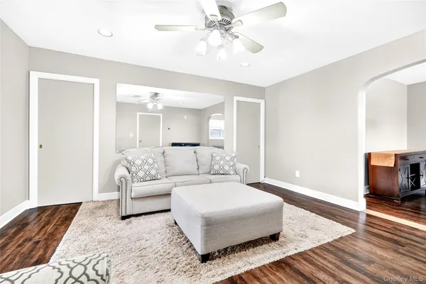 a living room with furniture and a chandelier